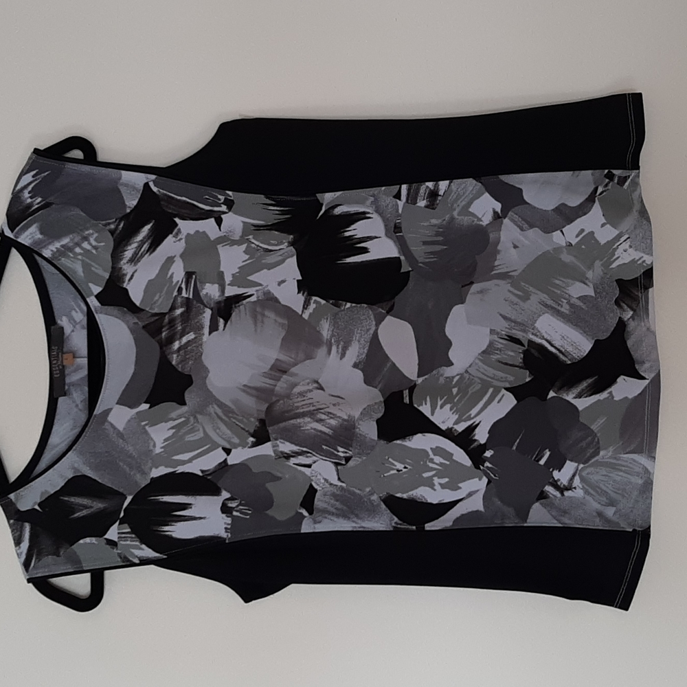 Multi colored sleeveless top in graphic design.  Like New